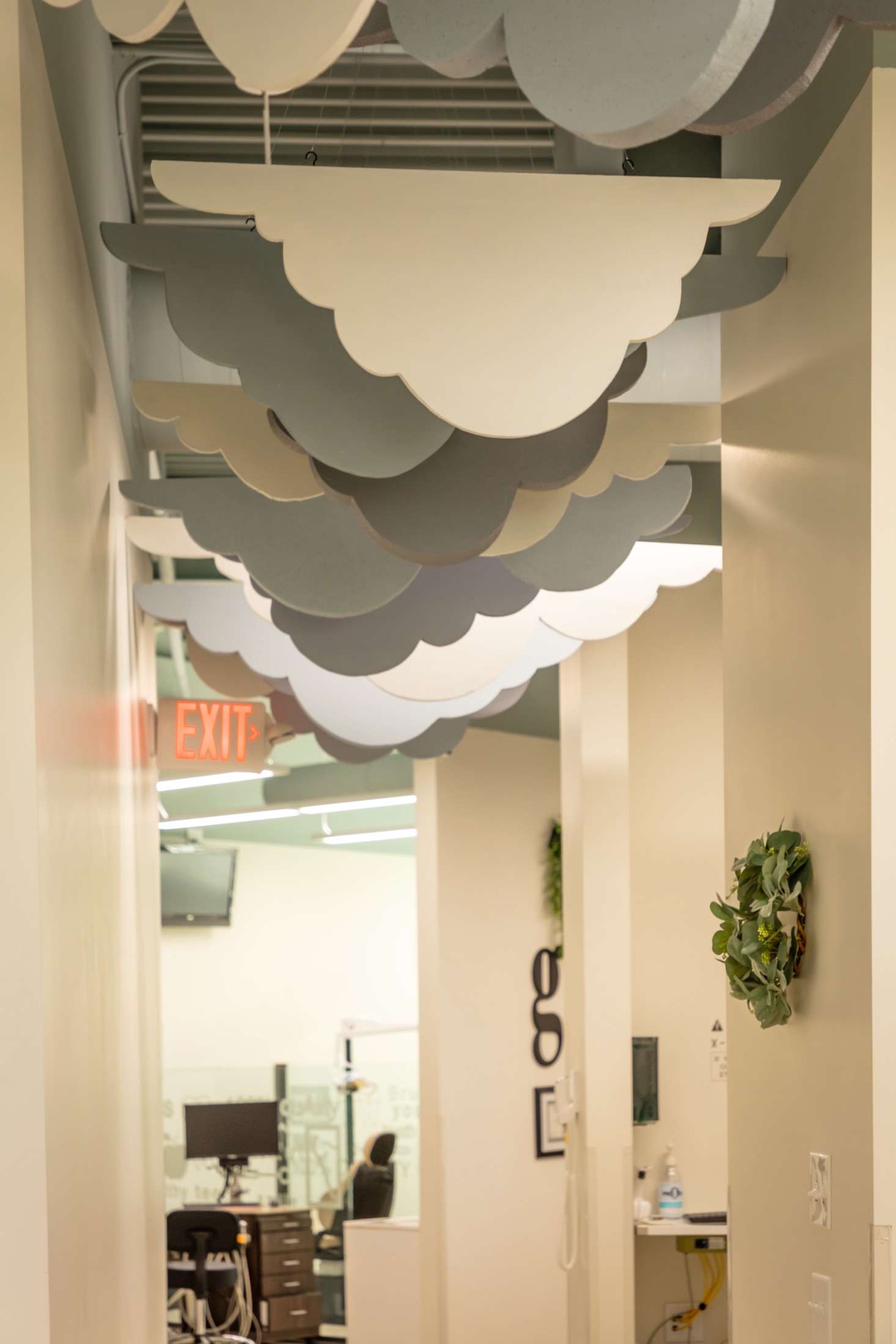 Layered cloud installation above a Growing Smiles hallway